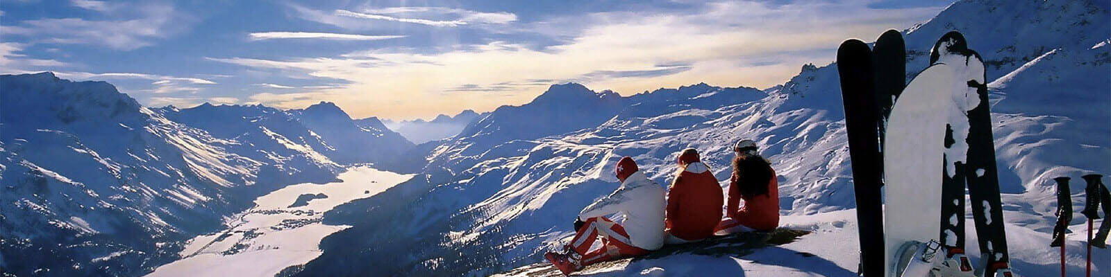 view of the mountains with three people in the foreground